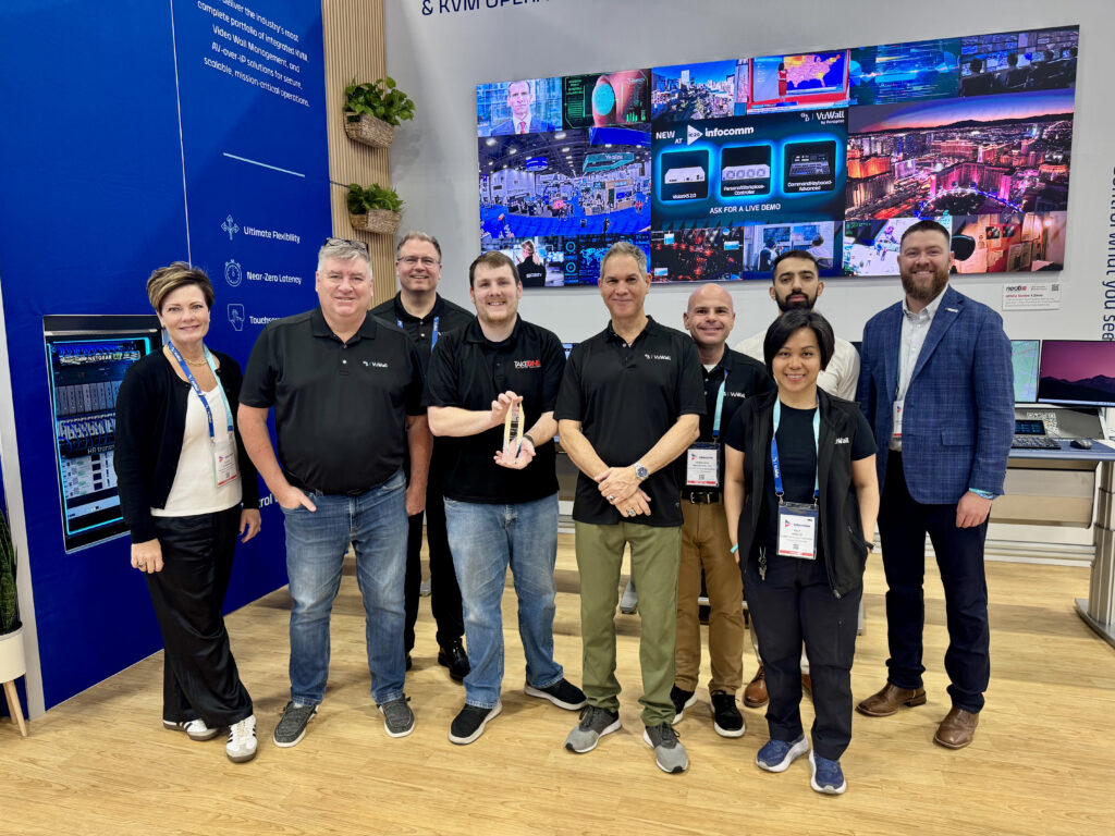 Patrick (TakeOne), accepts G&D's Reseller of the Year award during InfoComm 2026. Thompson is pictured with members of the G&D and VuWall teams.